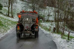 Italy 2023 Salt spreader truck in action to avoid the formation of ice on the road photo