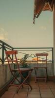 Outdoor terrace with chair and table, vintage filter effect. photo