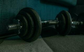 Dumbbells on a wooden floor. Close-up. photo