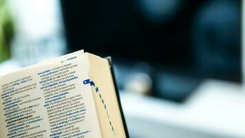 English dictionary open with the background of a living room photo