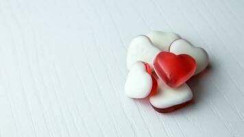 Heart shaped gummies on white background photo