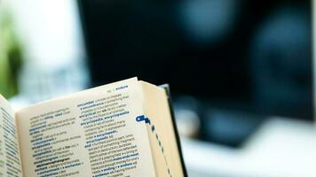 English dictionary open with the background of a living room photo