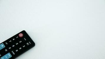 TV remote control on white background. Selective focus and shallow depth of field. photo