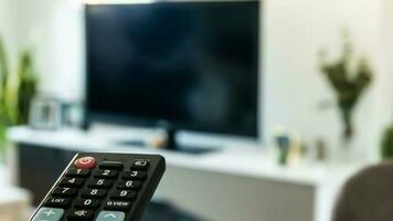 TV remote control on sofa in living room, blurred background with copy space photo