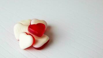 Heart shaped gummies on white background photo