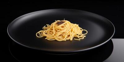 Delicious spaghetti on a black plate photo