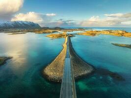 Aerial view of bridge over the sea and snowy mountains in Lofoten photo
