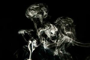 Smoke effect texture. Isolated background. Black and dark backdrop. Smokey fire and mistic effect. photo