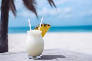 Summer coconut milk cocktail with slice of pineapple on a table in a cafe on the beach. Pina colada. . photo