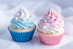 Cupcakes with blue and pink decoration on white background, close up view. Gender reveal party. . photo