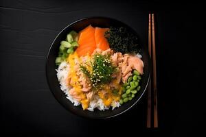Poke bowl with salmon, rice, seaweed and vegetables with chopsticks on black background, top view. . photo