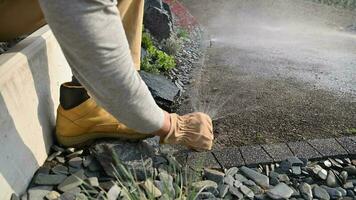 Landscaping Worker Adjusting Garden Water Sprinkler video