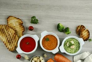 Broccoli, Carrot, and Tomato Soup. Soup Assortment. photo