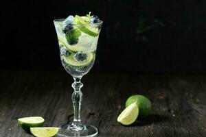 Lime Blueberry Carbonate Water on Black Wooden Table photo