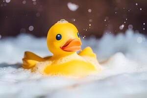 Yellow duck toy in soap foam water. . photo