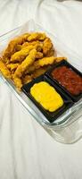 breaded fried chicken strips and sauces photo
