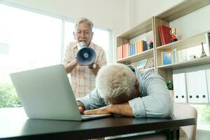 Old Asian elderly yell to a megaphone to talk with a friend for communication. Concept of communication problem in aging cause of ear be without hearing, deaf photo