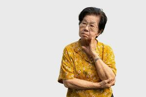 Tired upset mature old woman suffering from strong chronic headache migraine, patient holding head with her hand,suffering from senile dementia,memory disorders, confused and Alzheimer disease photo