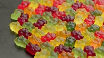 full frame looped spinning background of colorful jelly bear candies video