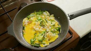 slow motion close-up of frying vegetables in pan with steam and without lid video