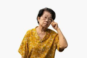 Tired upset mature old woman suffering from strong chronic headache migraine, patient holding head with her hand,suffering from senile dementia,memory disorders, confused and Alzheimer disease photo