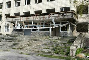 Burnt apartments in a multi-storey residential building, the consequences of the war in Ukraine. Buildings damaged by shells. Real creepy footage of the war in Ukraine. Remains of property. photo