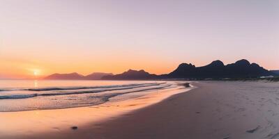 Sunset on the beach with mountains in the background photo