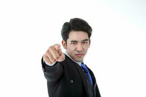 Southeast Asian young office business man wearing suit finger pointed want you expression look at camera on white studio background photo