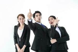 Southeast Asian young office business man woman wearing suit point finger showing up expressions surprise wonder wow on white studio background photo