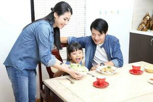 South East Asian young father mother daughter  parent girl child activity indoor photo