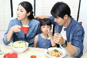 South East Asian young father mother daughter  parent girl child activity indoor photo