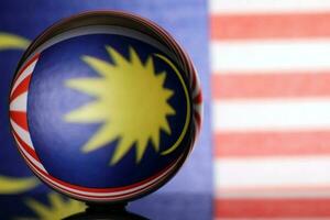 Malaysian flag refraction through glass crystal ball country independence patriot concept photo