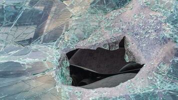 Broken windshield from a car accident. The windshield of the car was broken. Broken windproof car accident. Car accident. A window repair company will come to you to replace the broken glass. photo
