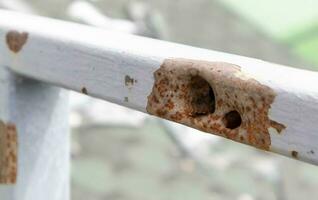 Bullet hole in the pipe. War in Ukraine. A hole from a shell fragment. Consequences of the war. Holes from shots on a metal pipe. photo