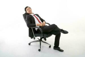 Asian young Chinese man wearing formal business office ware on white background sitting on office chair relax think success happy worried photo