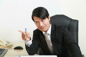 Young Asian man woman wearing business office suit chair table computer white background photo