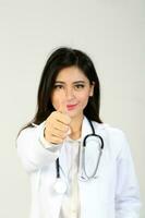 Young Asian female doctor wearing apron stethoscope thumbs up photo