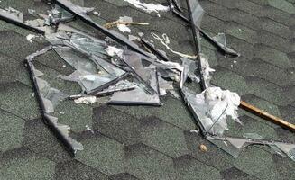 Broken roof after a storm. A large building with a damaged roof after a strong hurricane with broken glass and window frames. photo