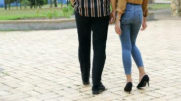 Young Asian Malay man woman couple outdoor green park walk talk discuss mingle legs photo