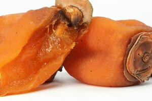 dried permission fruit on white background photo