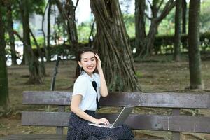 Young asian chinese woman outdoor park campus book photo