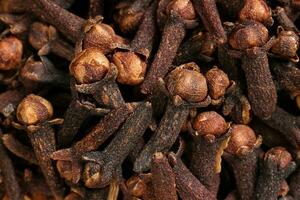 Fragrant dry clove but spice macro closeup top view pileup photo