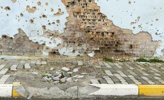 War in Ukraine. Funnel from the explosion in the asphalt. The trace left by the explosion of an artillery shell. Consequences of the rocket attack. Drone attack. photo