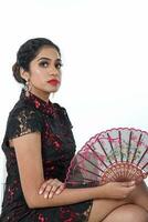 South east Asian Indian race ethnic origin woman wearing Chinese dress costume Cheongsam holding hand fan multiracial community on white background photo