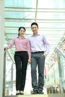 Young south east Asian middle eastern man woman business colleague outdoor stand pose photo