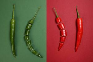 whole green red chilli pepper on green red paper background cut pieces seeds photo