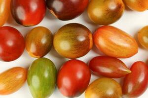 Fresh ripe mixed tomato verity assorted color on white background photo