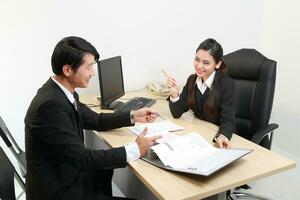 Young Asian man woman wearing business office suit chair table computer white background photo