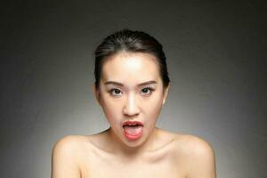 Young beautiful Asian woman facial expression photo