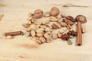 Nuts spice mix on rustic wood photo